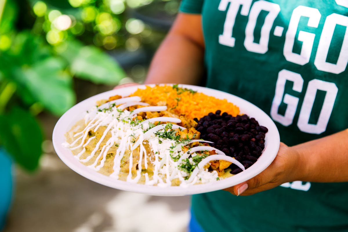 a person holding a plate of food