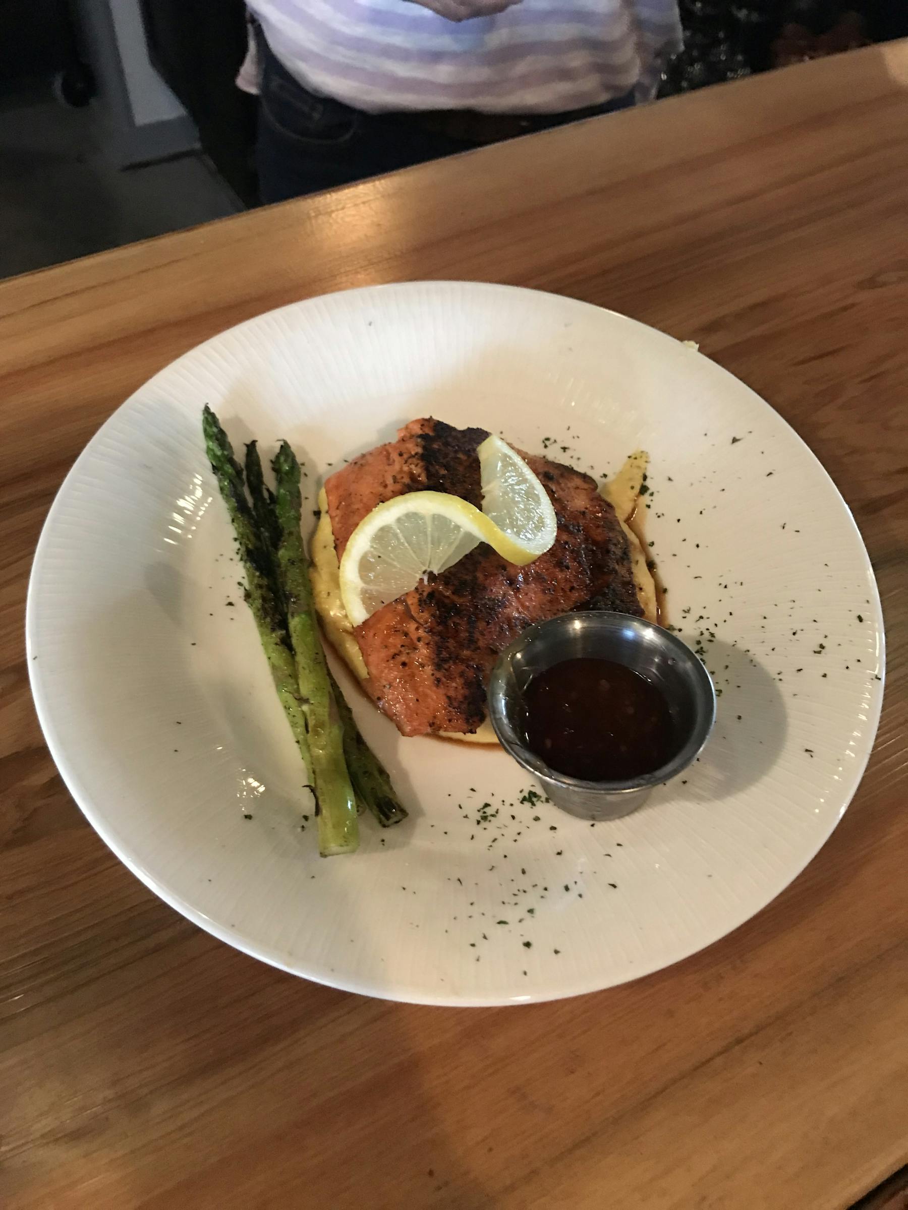 a plate of food sitting on top of a wooden table
