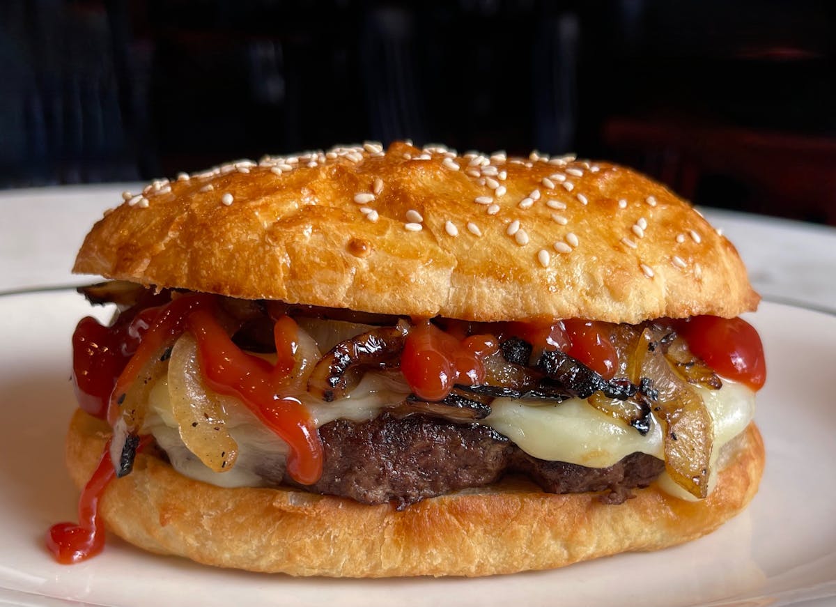 a close up of a sandwich sitting on top of a bun