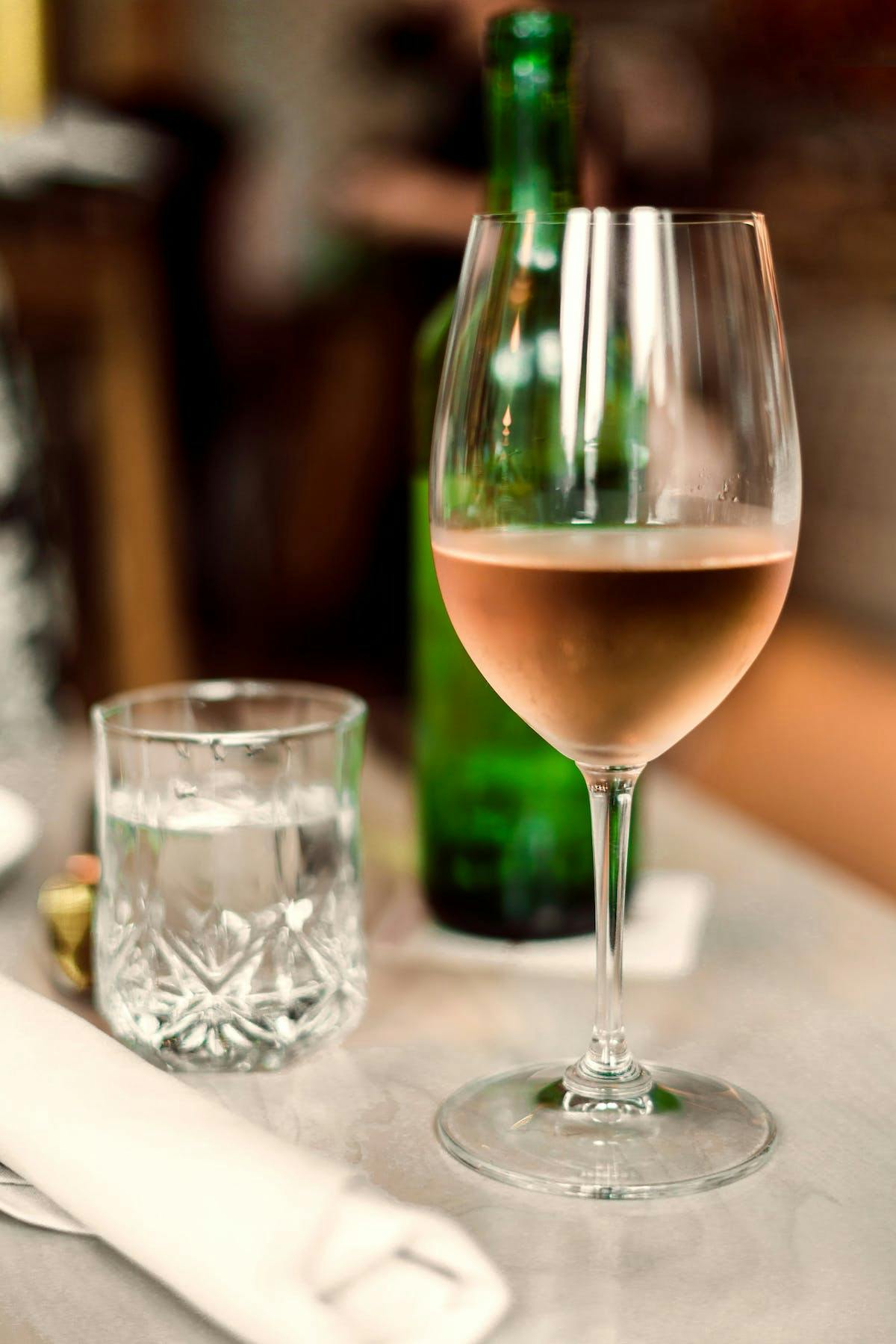 a close up of a wine glass sitting on a table