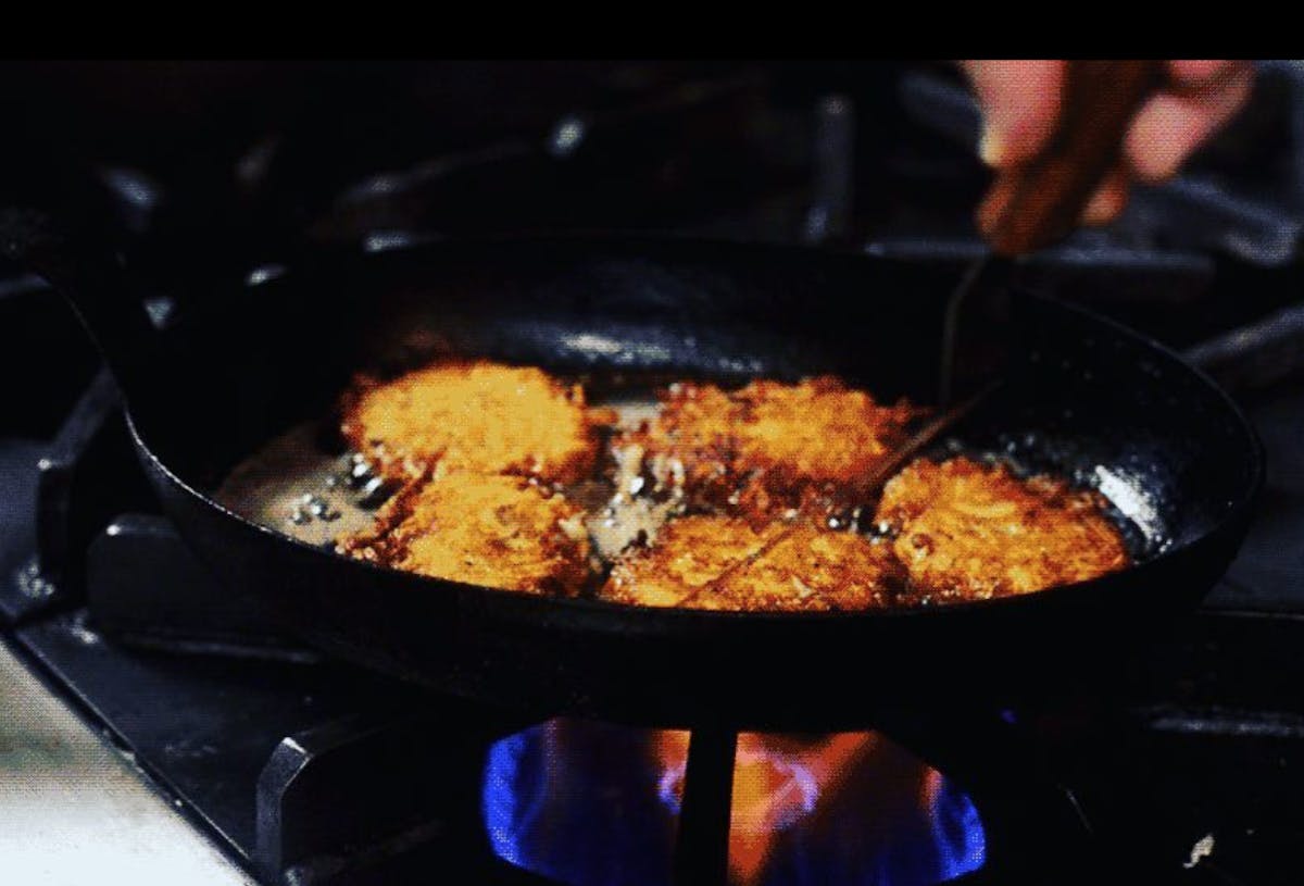 a pizza sitting on top of a pan on a stove