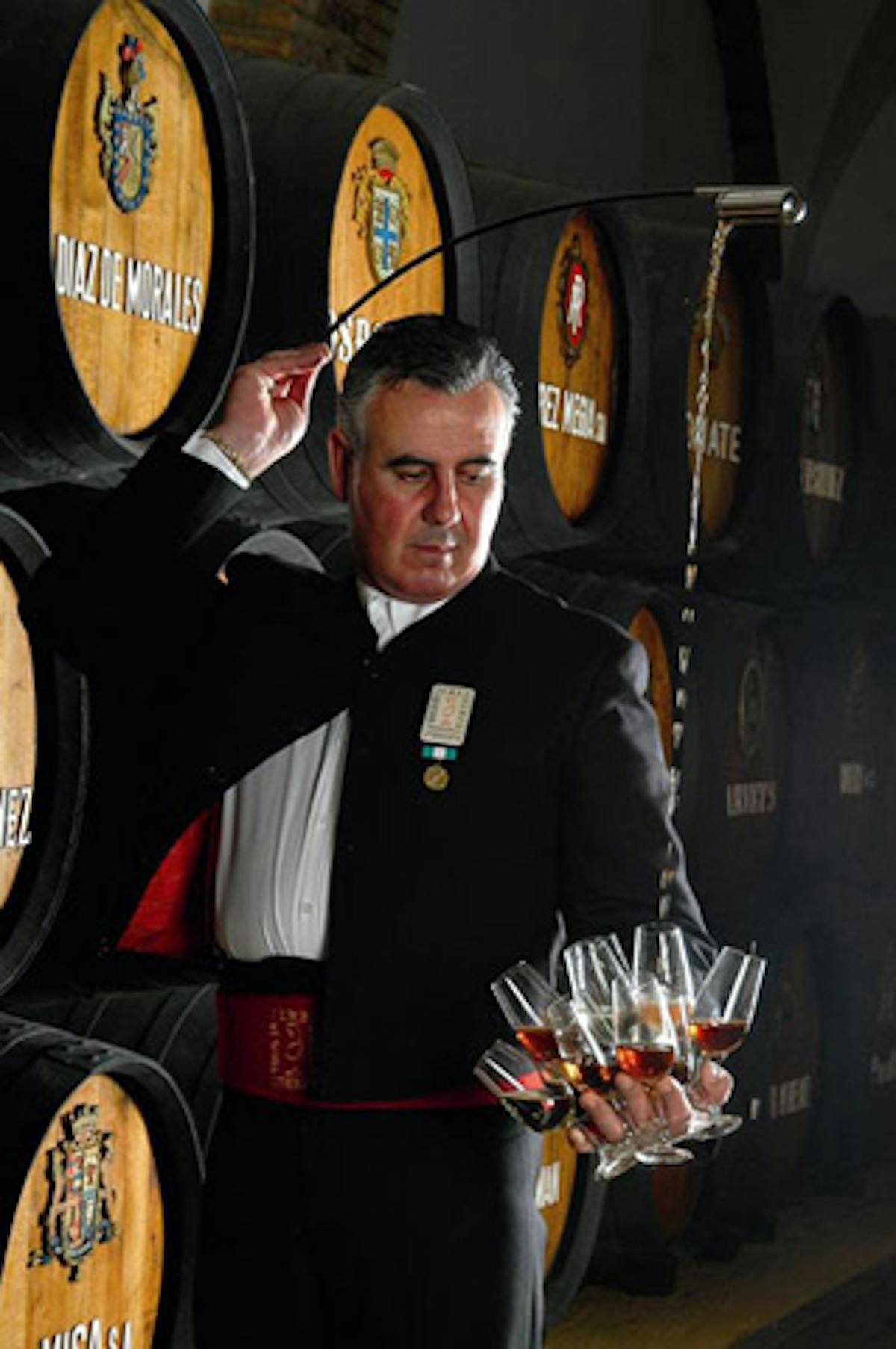 a man standing in front of a barrel