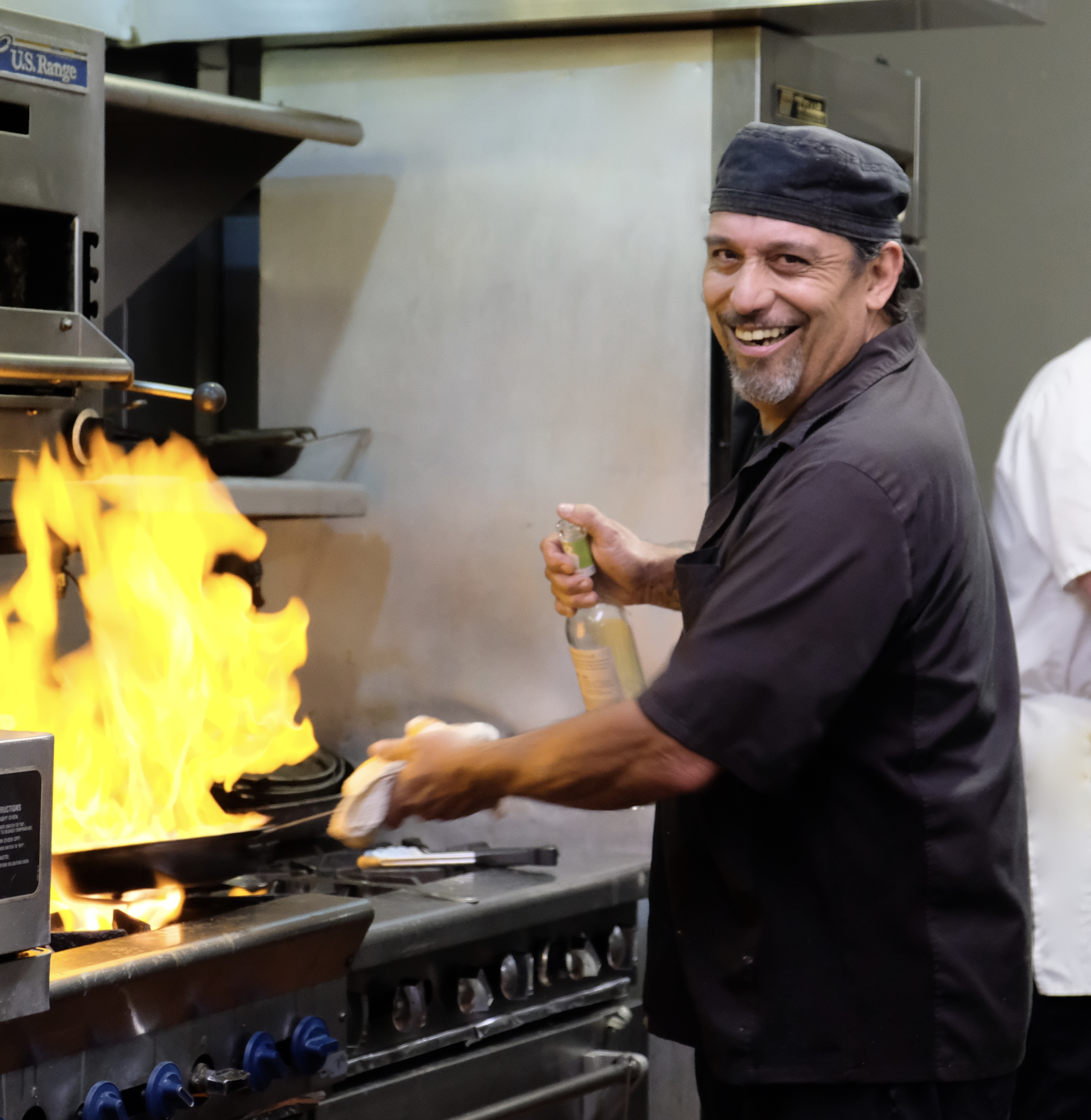 a man cooking in a kitchen preparing food