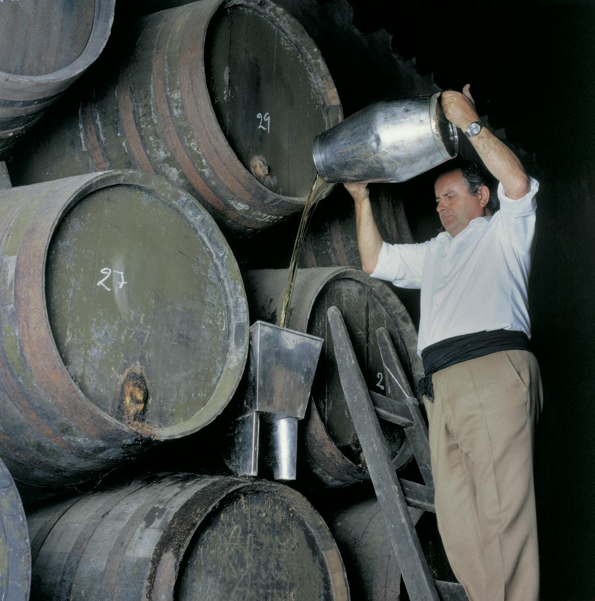 a person standing in front of a barrel
