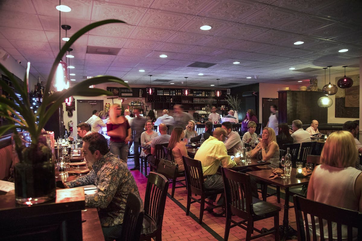 a group of people sitting at a table in a restaurant