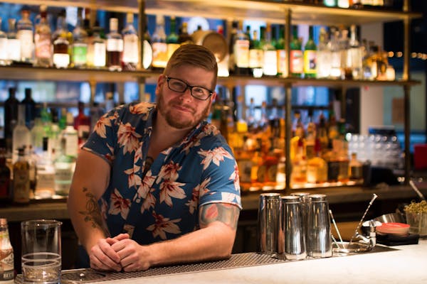 a person sitting at a table with wine glasses