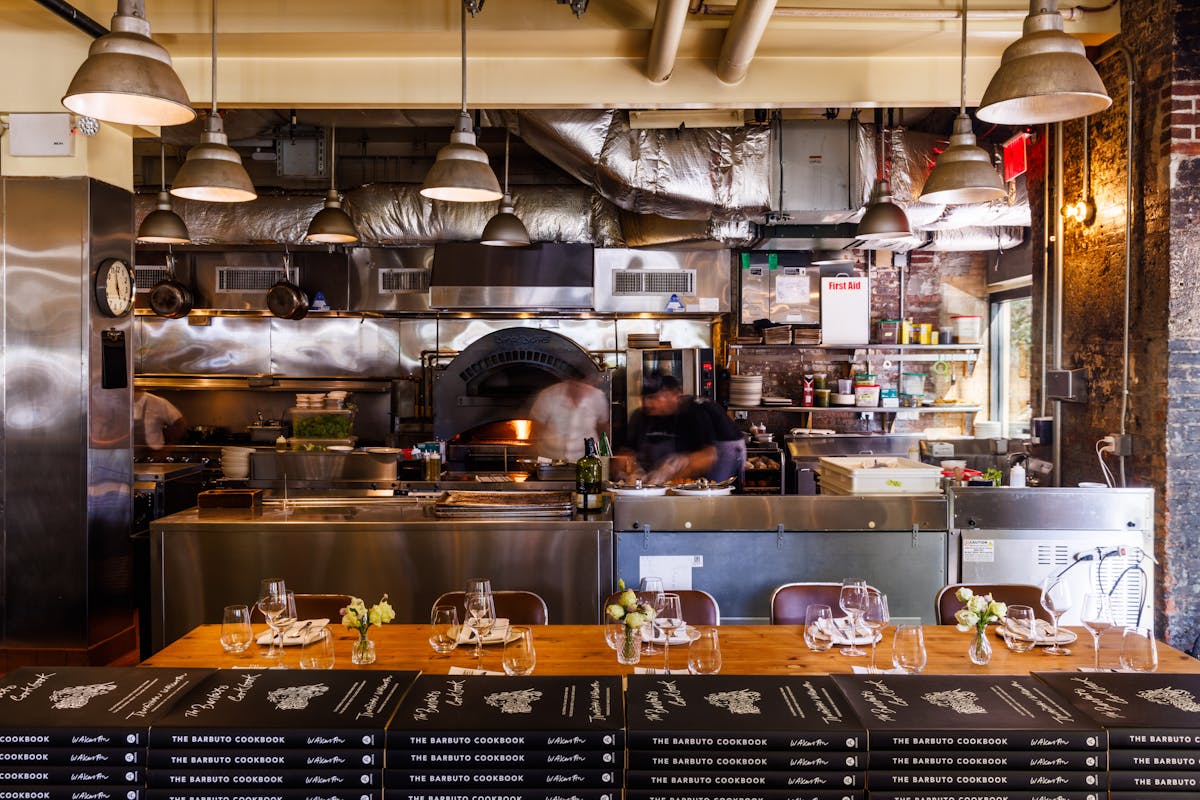 a kitchen with a table in a restaurant
