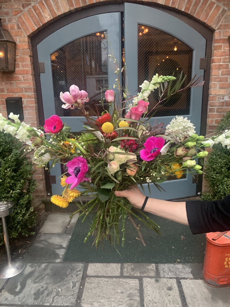 a vase of flowers on a brick building