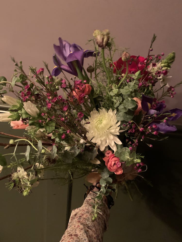 a bouquet of flowers in a vase on a table