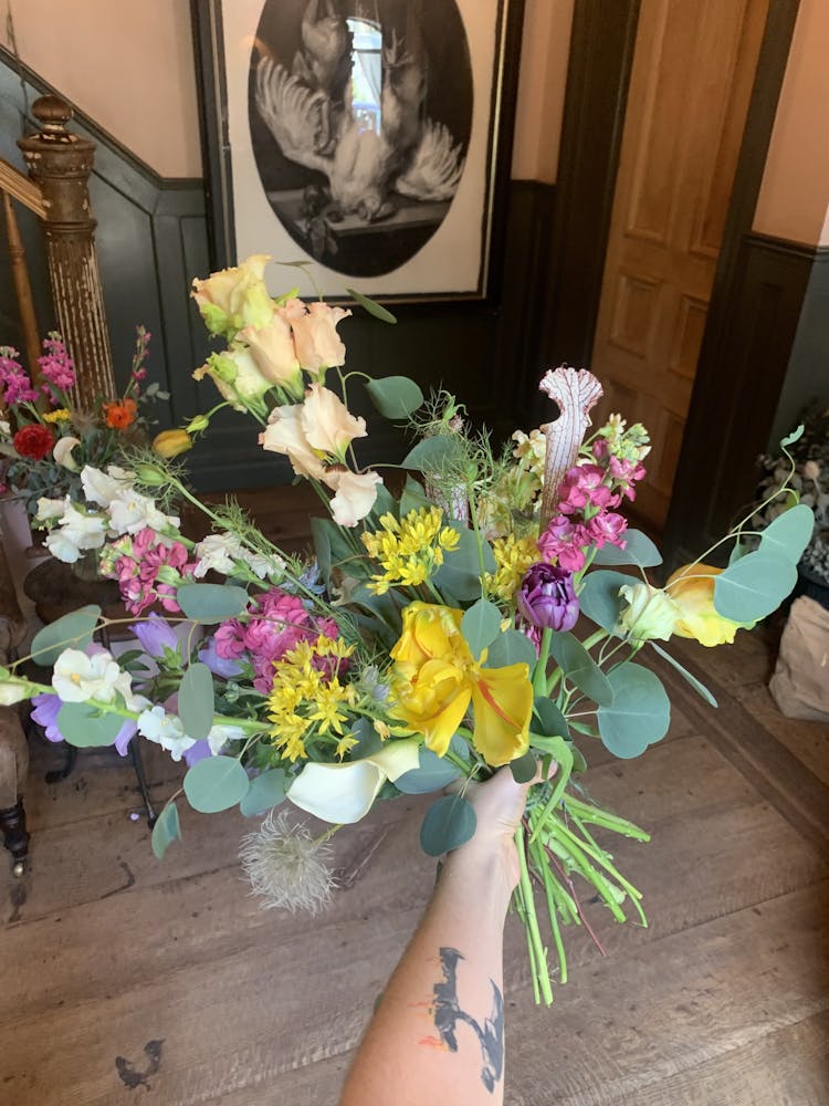 a bouquet of flowers in a vase on a table