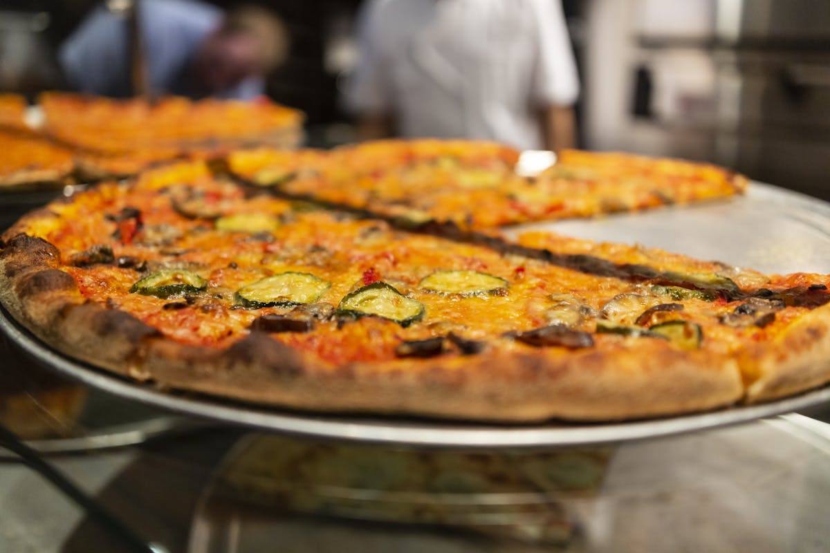 a pizza sitting on top of a pan on a table