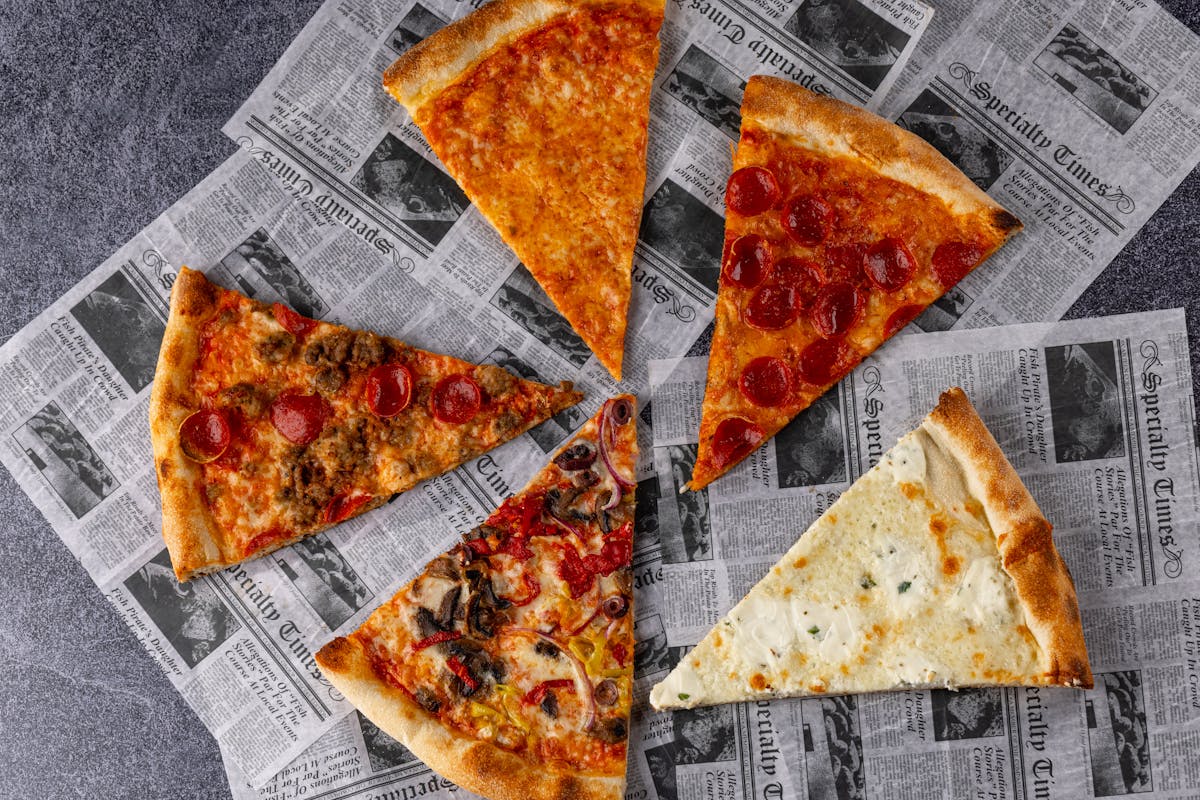 a slice of pizza sitting on top of a piece of paper