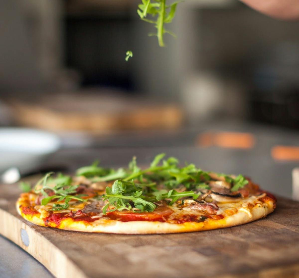 a pizza sitting on top of a cutting board