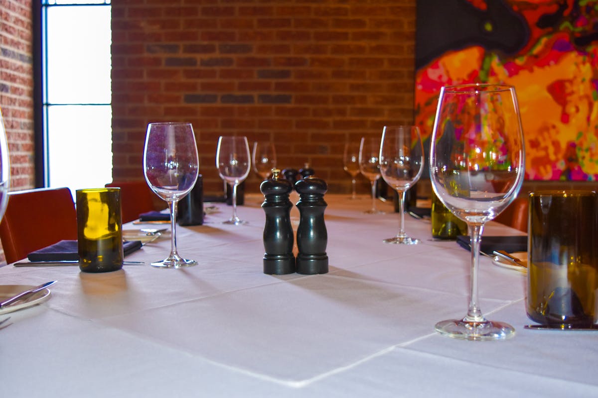 a table topped with glasses of wine