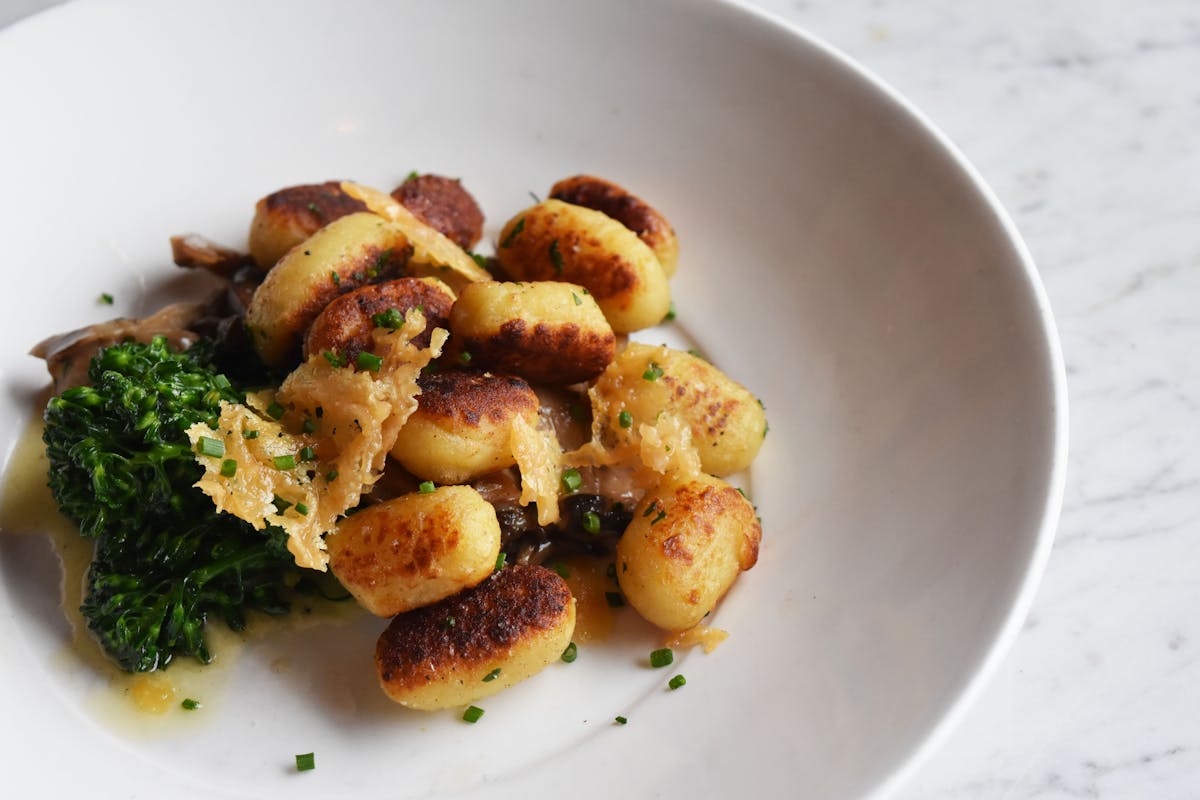 a white plate topped with meat potatoes and broccoli