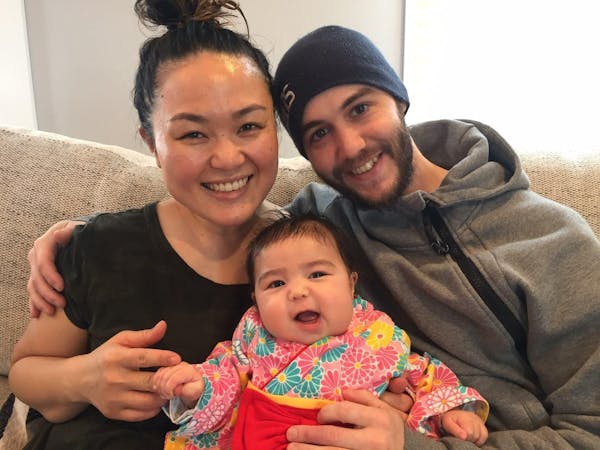 a man and a woman holding a baby