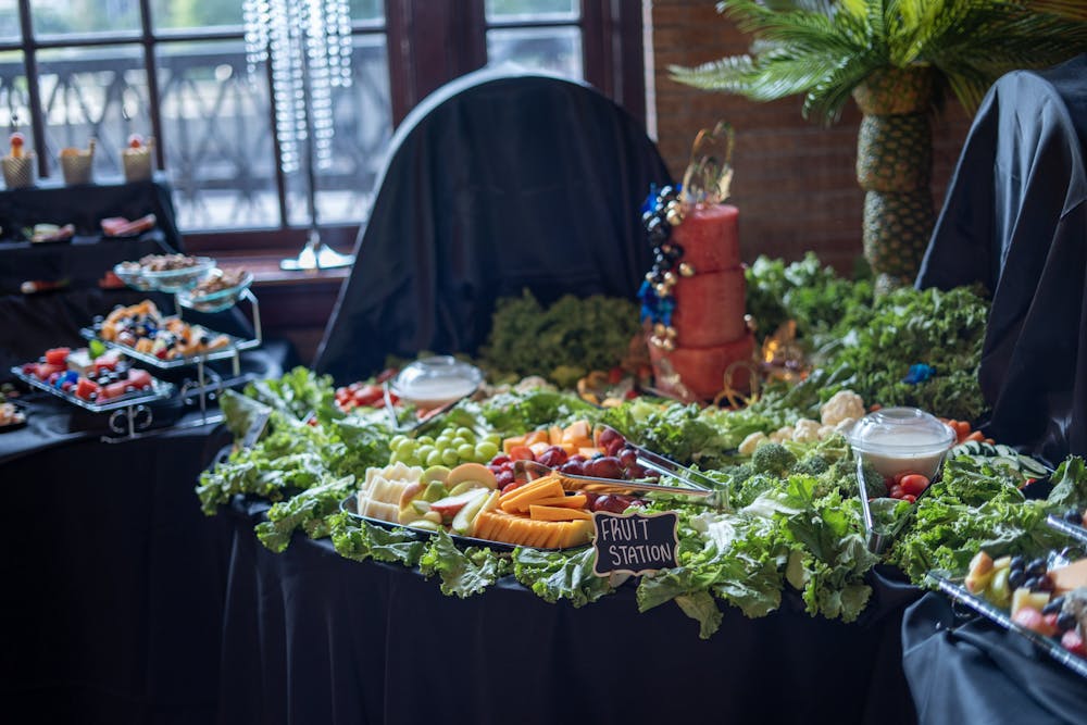 a group of people sitting at a table with food