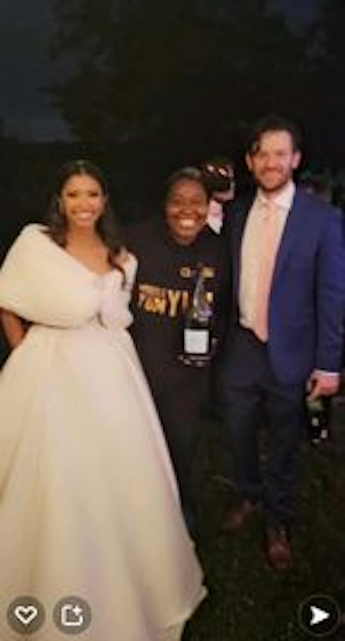 Bride, Groom & Chef Niki of people posing for the camera at wedding reception