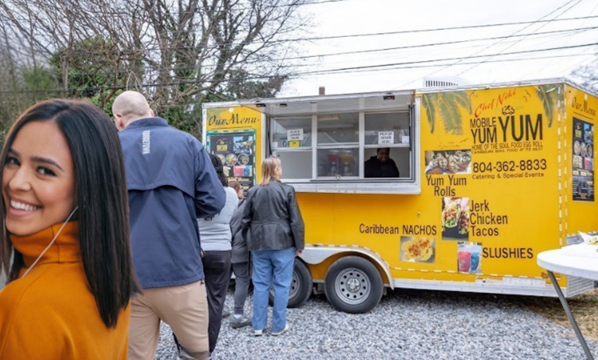 a group of people standing in front of a bus