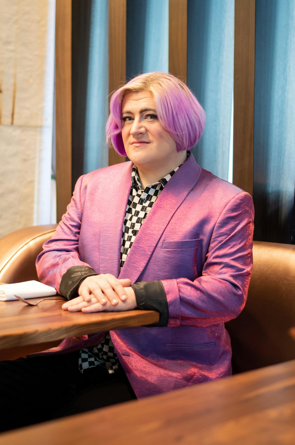 a woman sitting on a wooden table