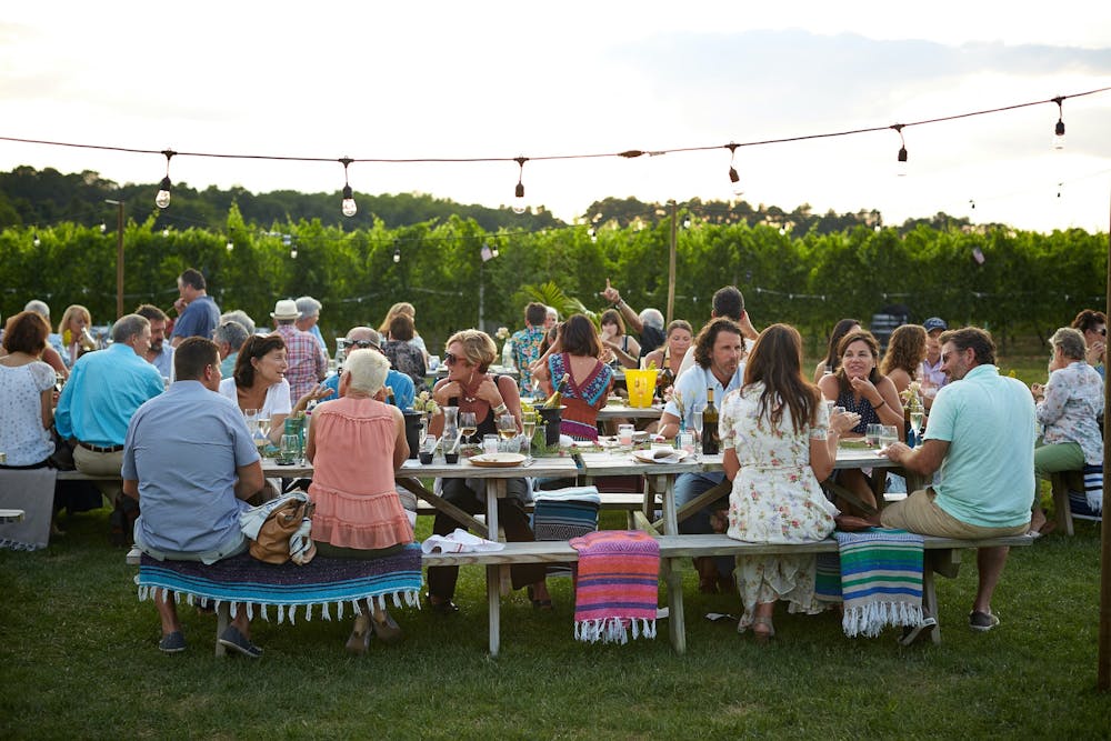a group of people that are standing in the grass, event planning service
