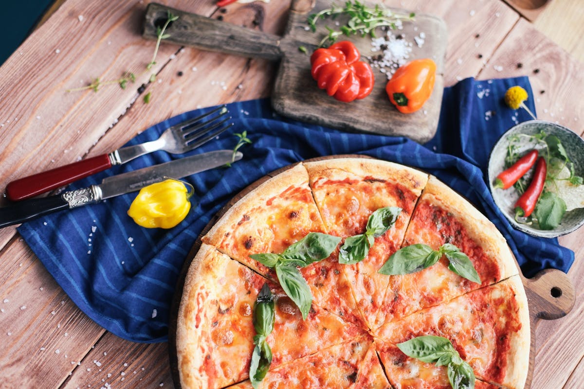a pizza sitting on top of a wooden cutting board