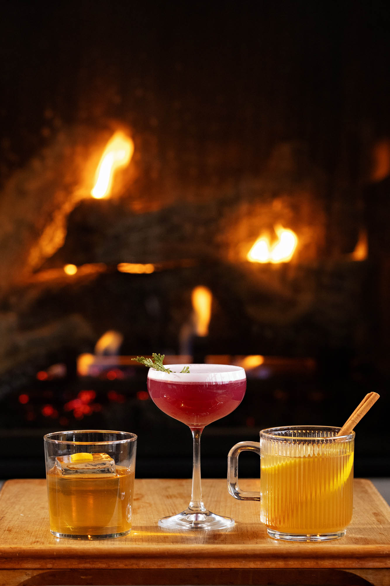 a glass of beer on a table with wine glasses