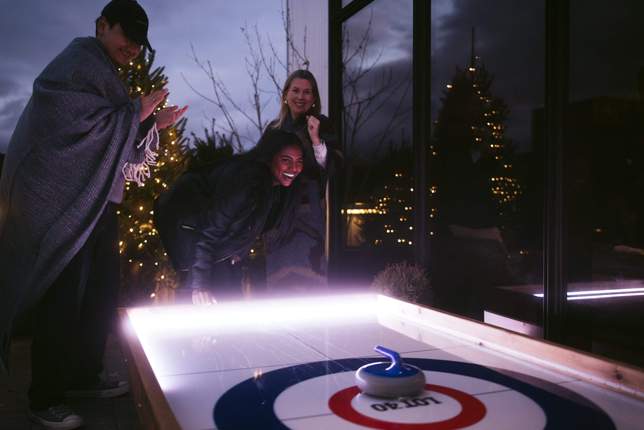 Chrissie Russell sitting at a table in front of a cake with lit candles