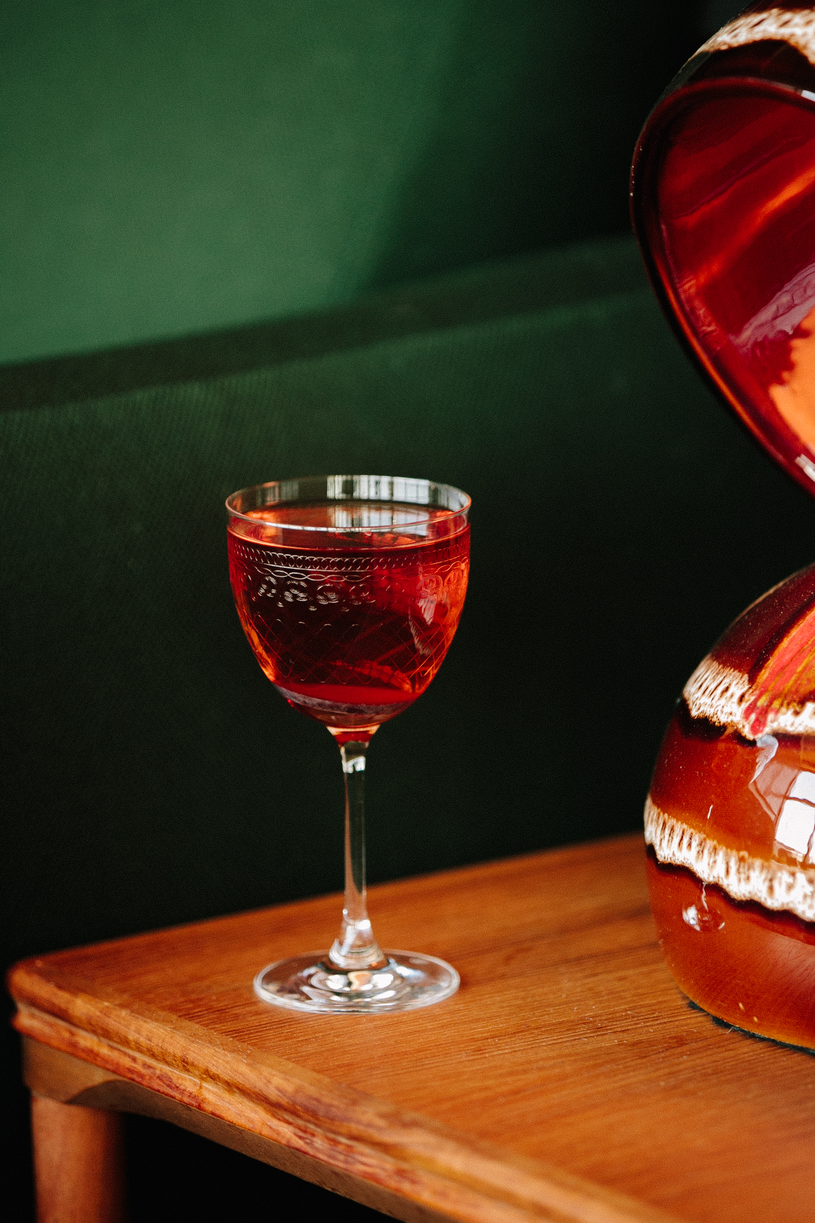 a close up of a wine glass sitting on a table