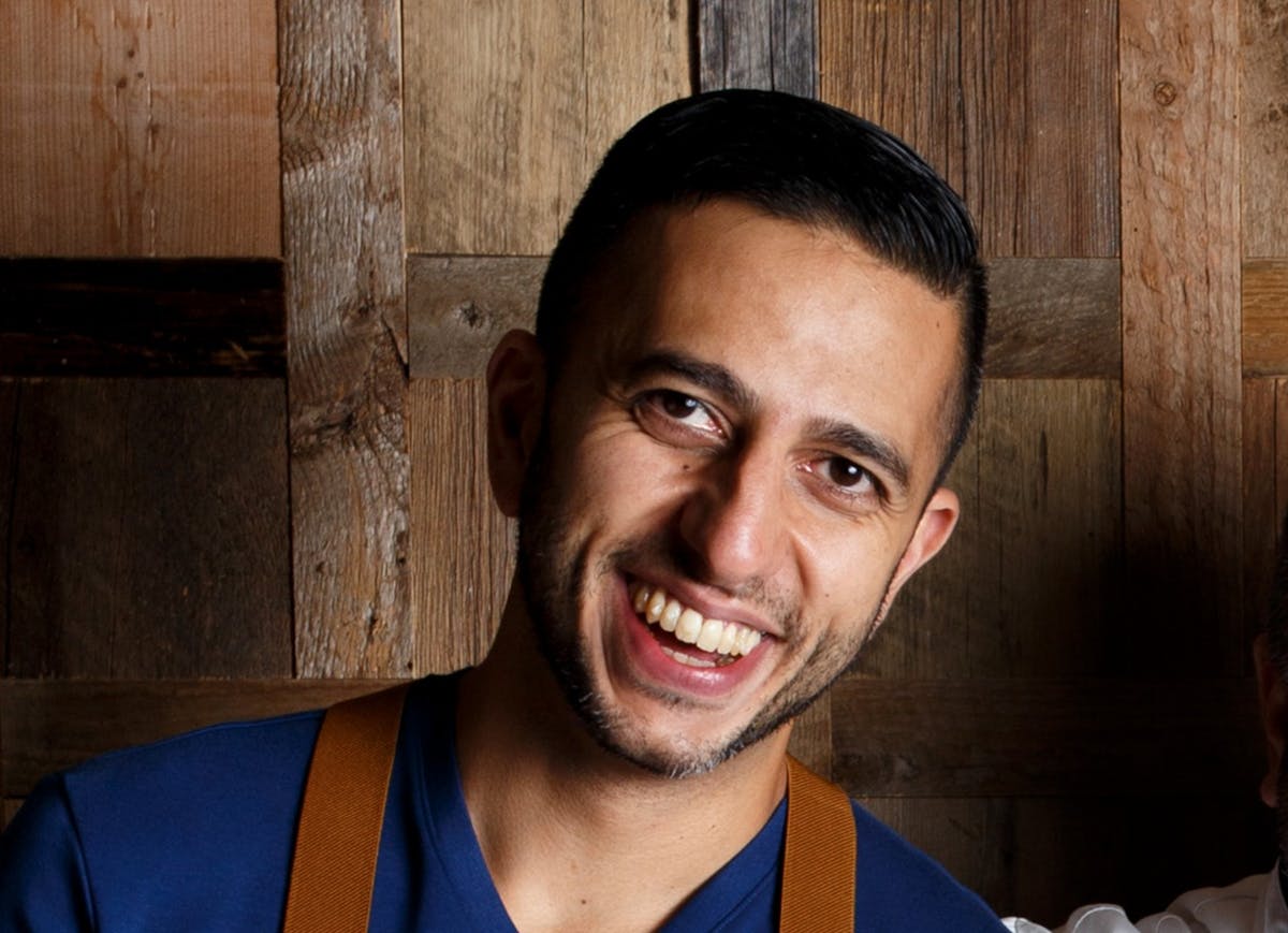 Robert Kharazmi standing in front of a wooden wall at Braidwood Tavern in Four Seasons Resort Whistler