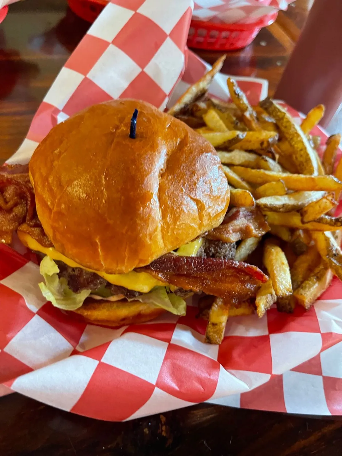 a basket of fries and a sandwich on a plate