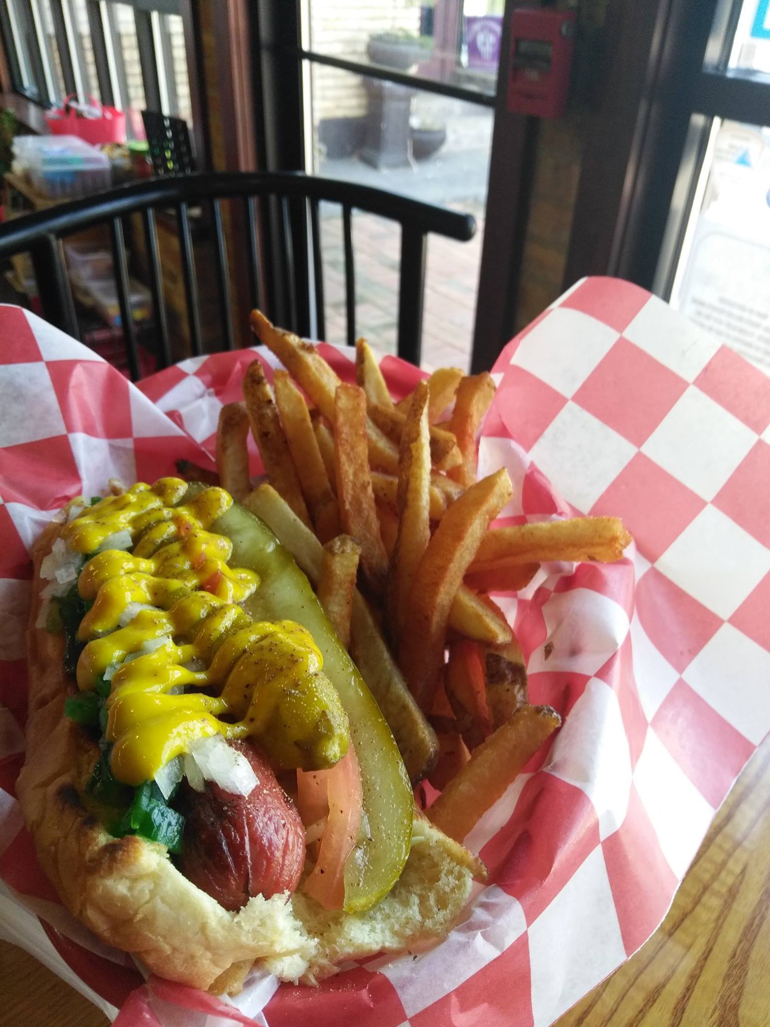 a hot dog that has a sandwich and fries on a plate