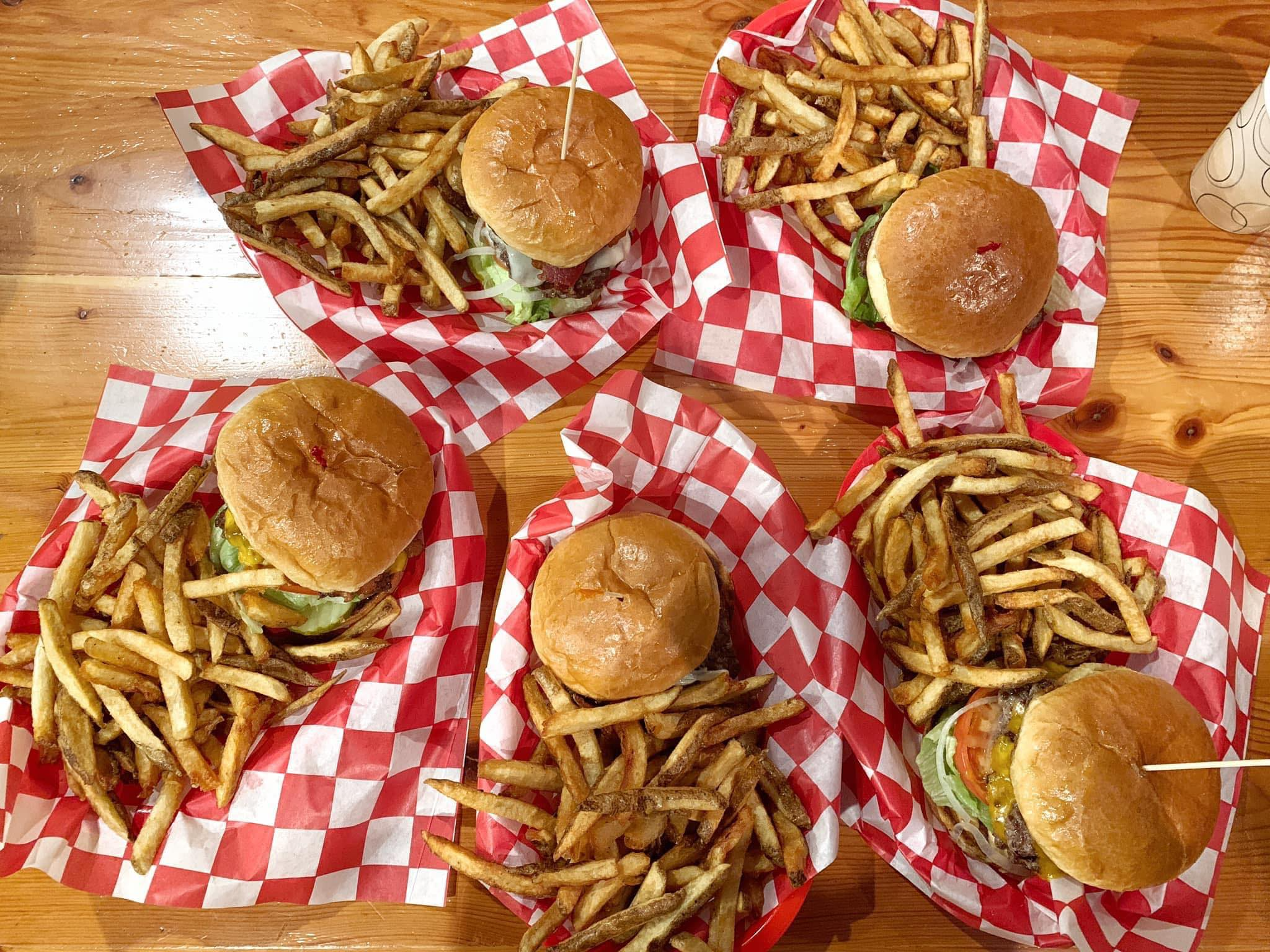 a table topped with a sandwich and fries