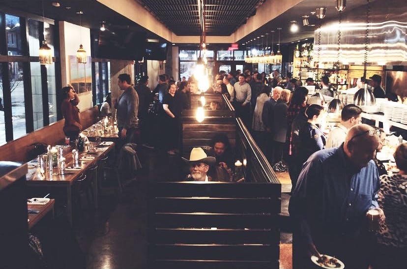 a group of people sitting at a table in a restaurant