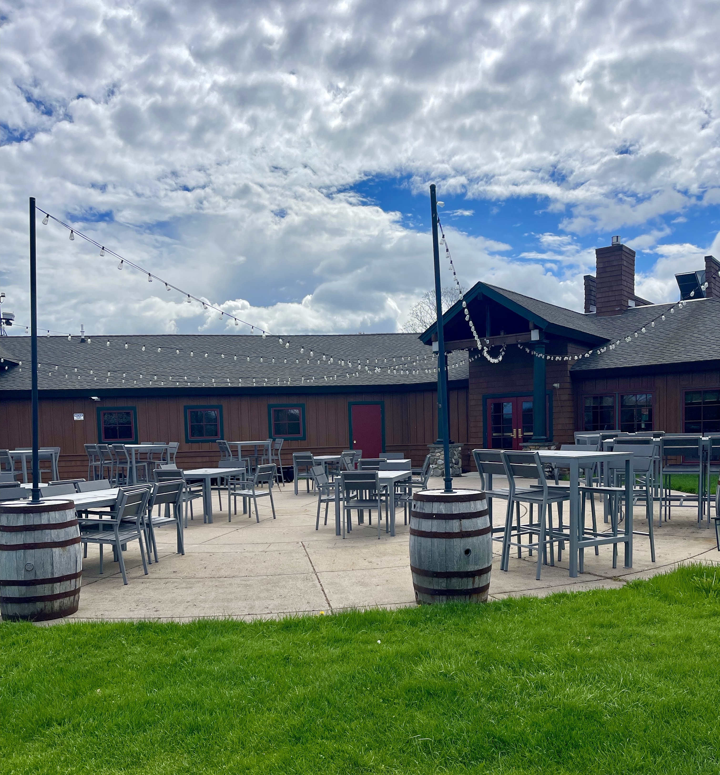 a patio with tables and chairs outside of a building