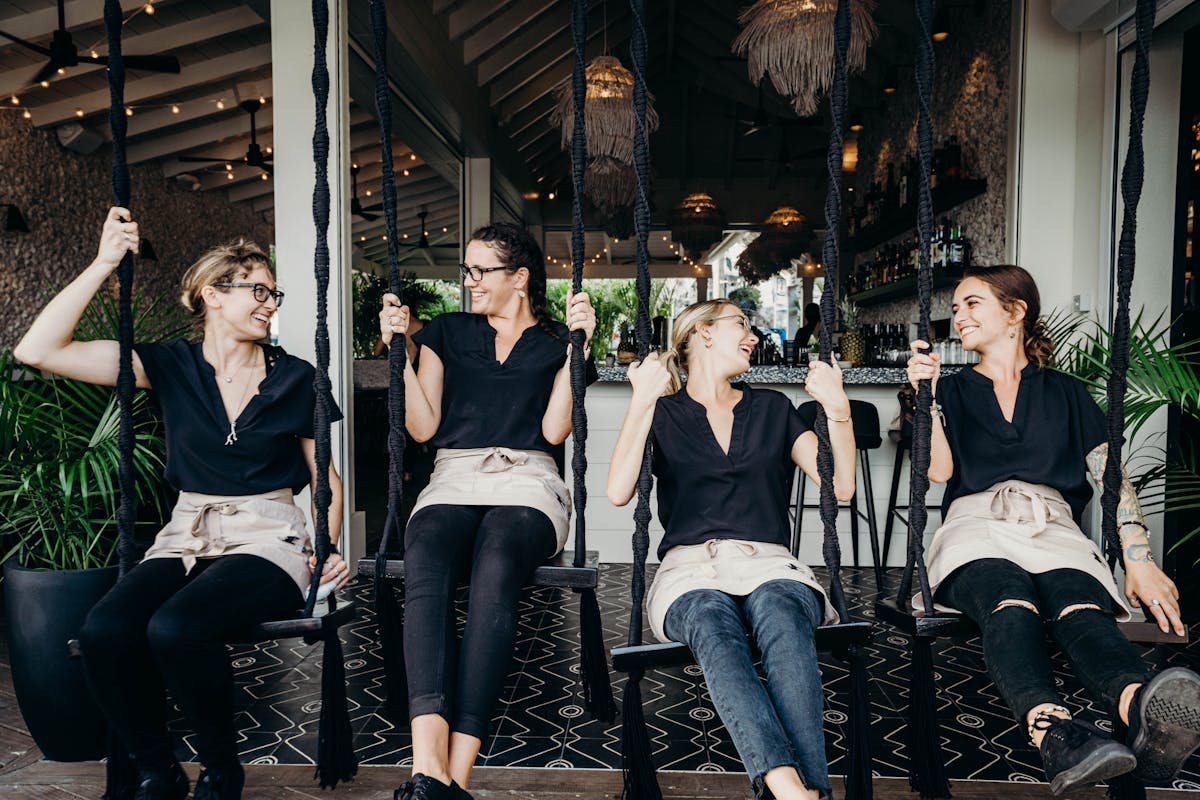 women on swings from a bar room