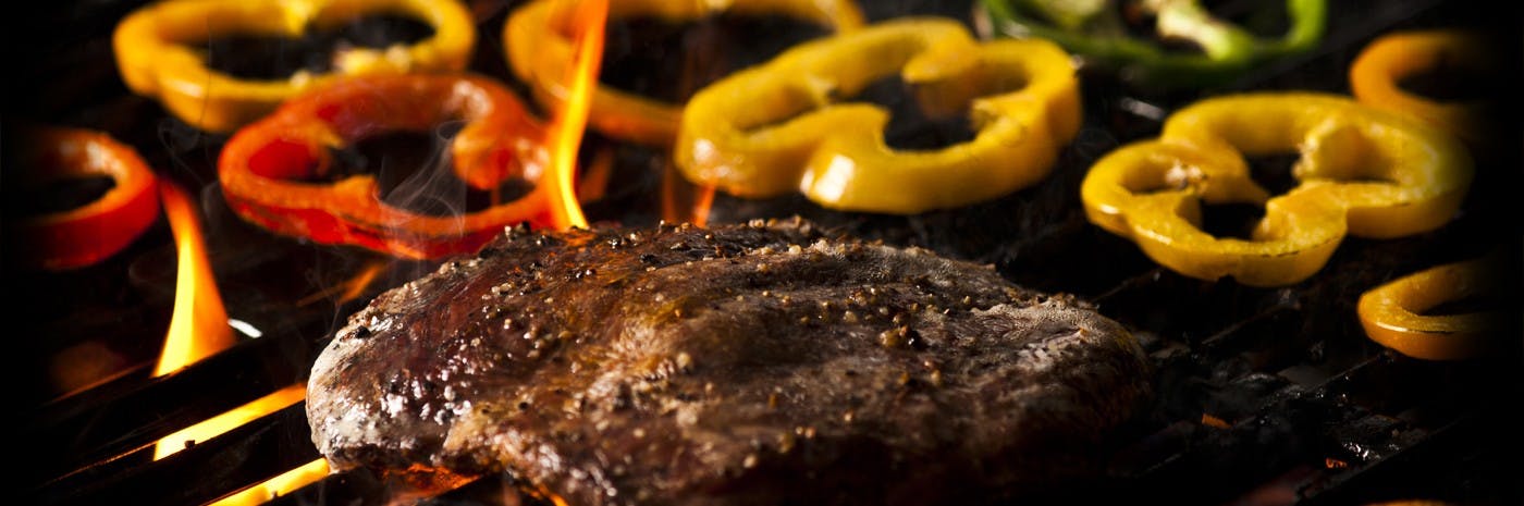a close up of a steak being grilled