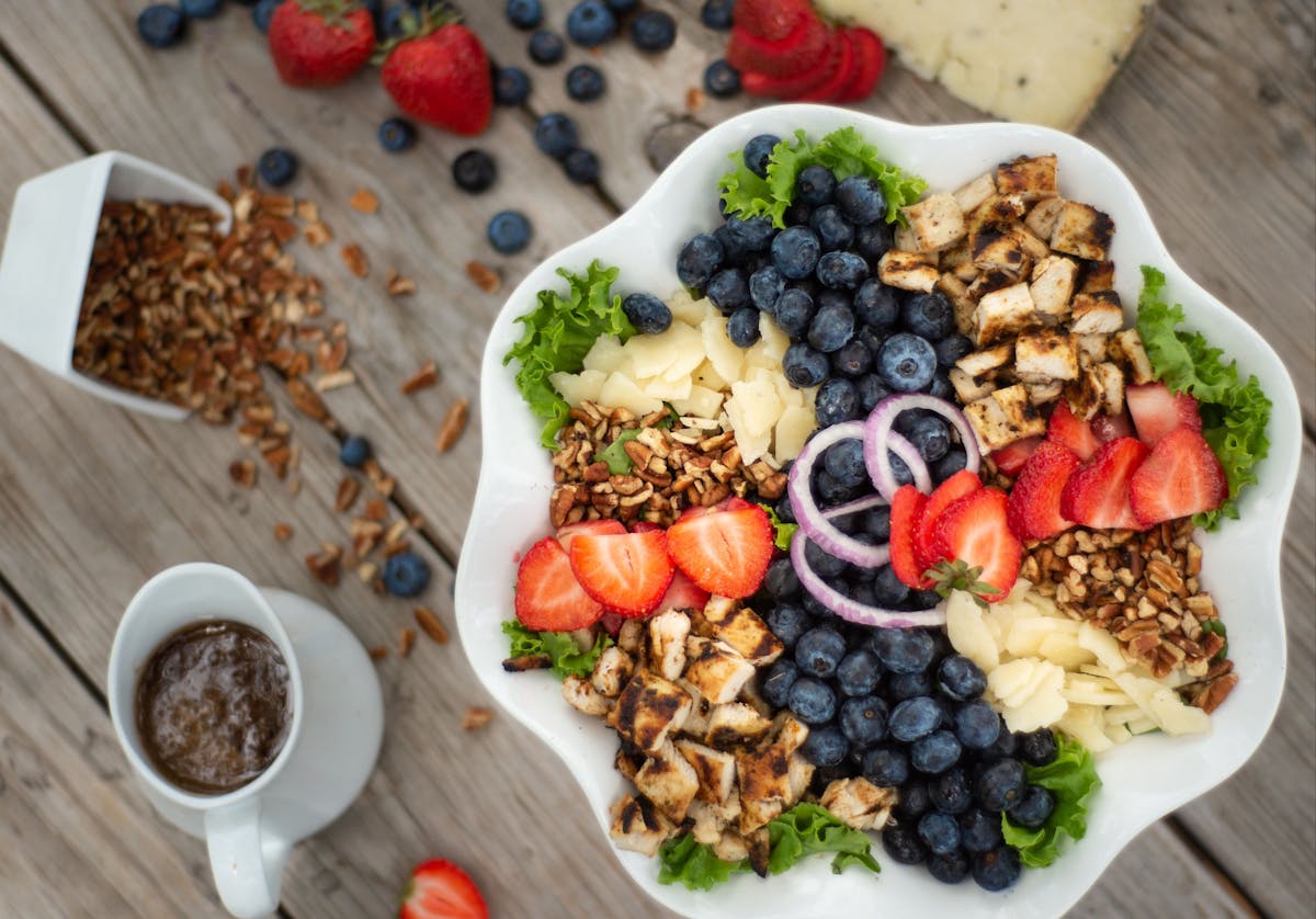 a plate of food sitting on top of a wooden table