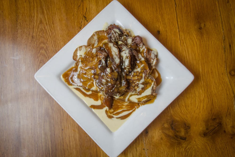 a plate topped with sauced and grilled pieces of chicken breast