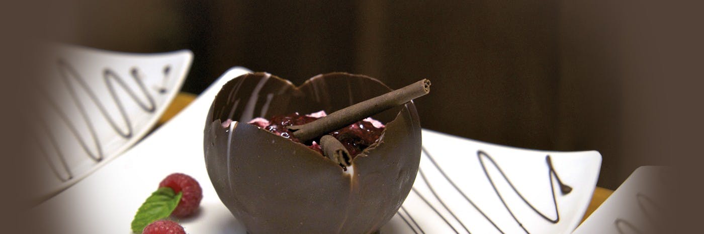 a chocolate bowl filled with strawberry jam