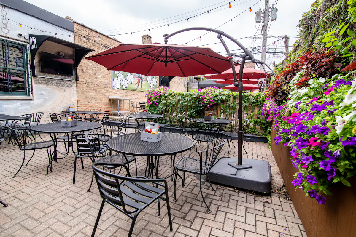 a table that has a umbrella in front of a building