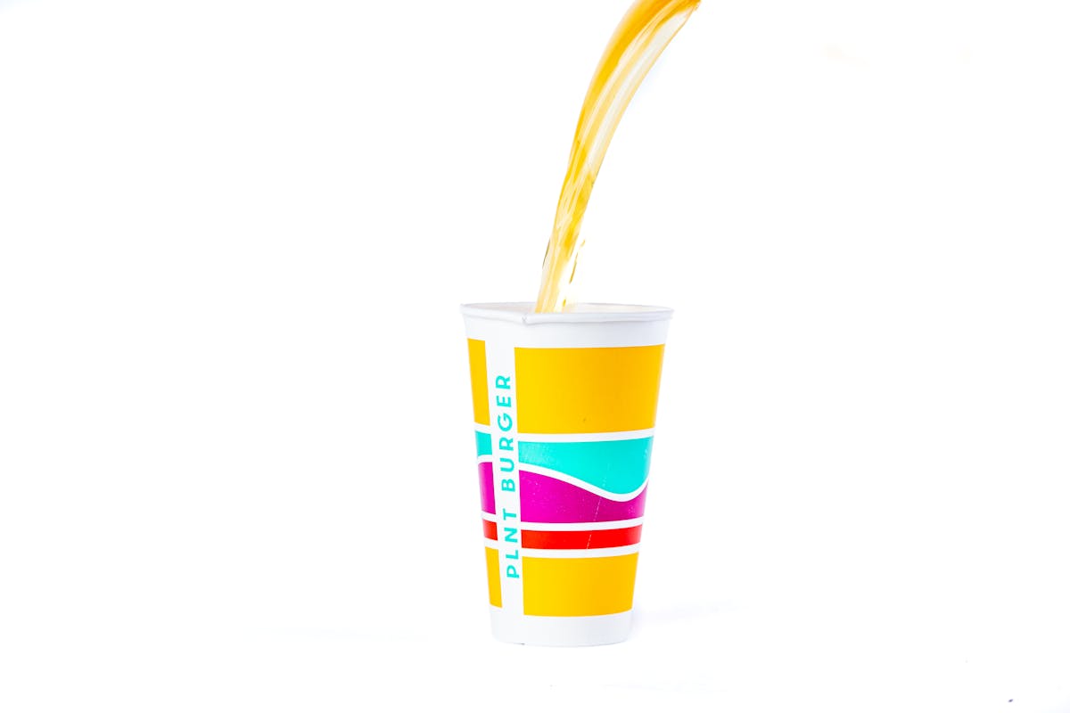 a soft drink being poured into a cup