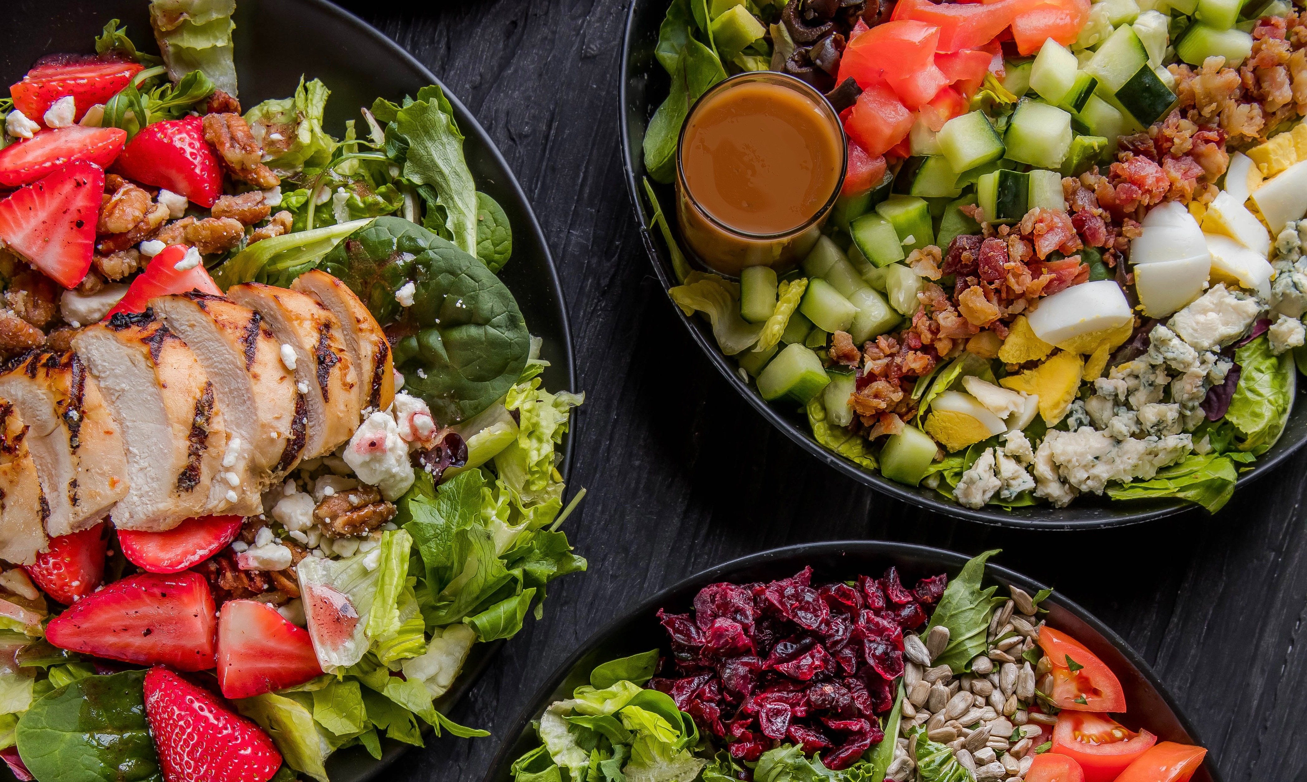 a group of plates of salad