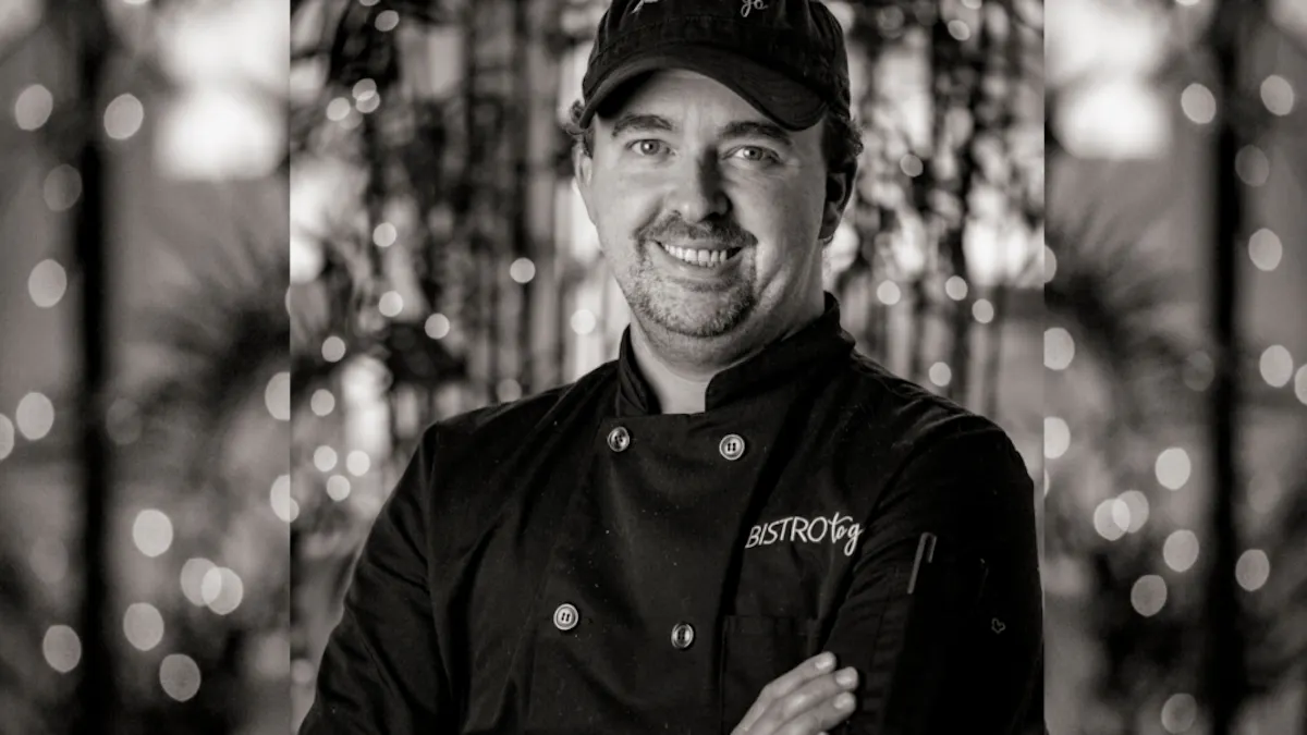a man wearing a black hat and black coat