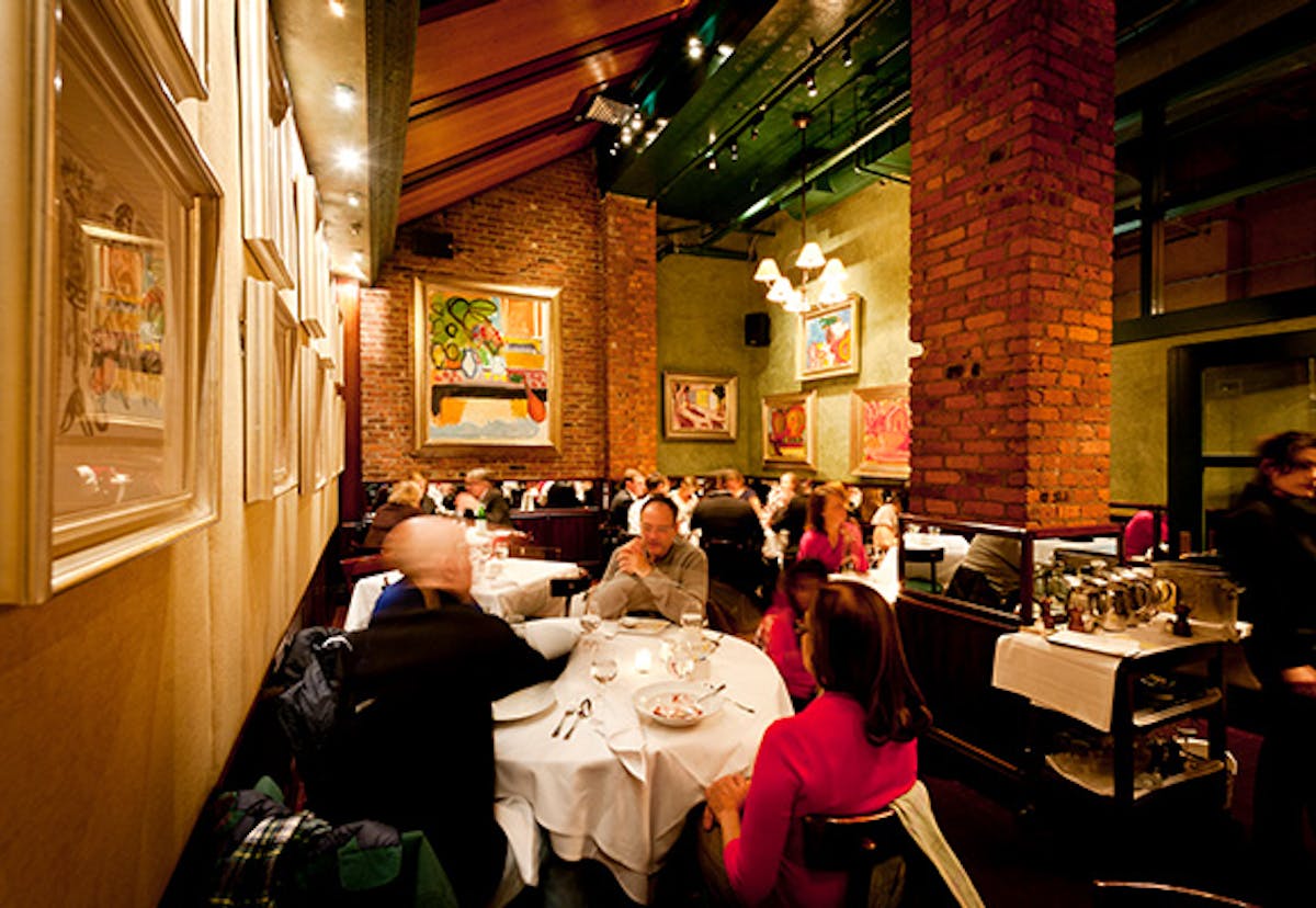 a group of people sitting at a table in a restaurant