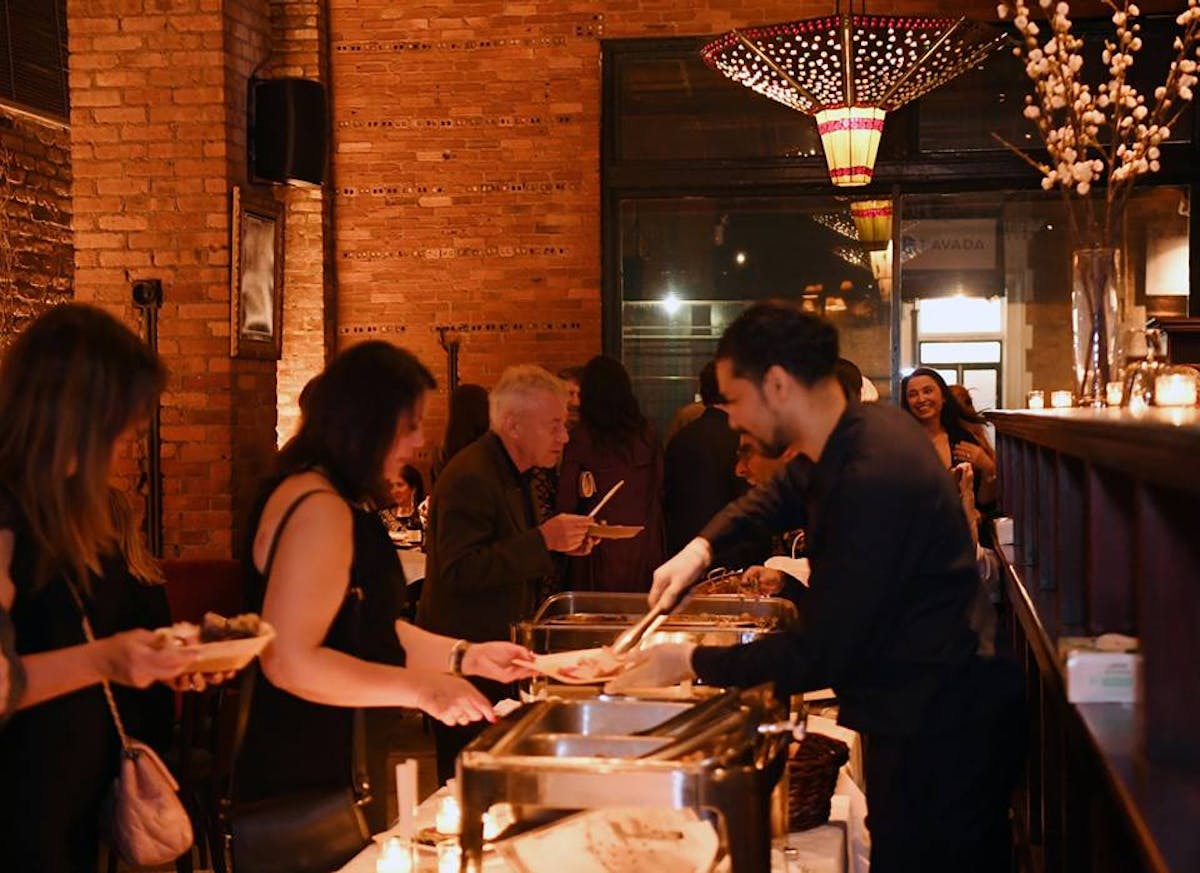 a group of people sitting at a table in a restaurant