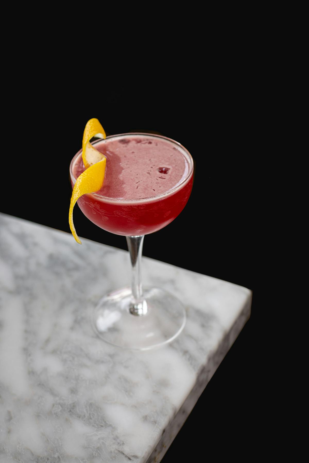 a cocktails with a lemon twist on a table