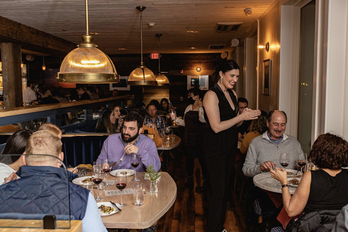 a group of people sitting at a table with wine glasses