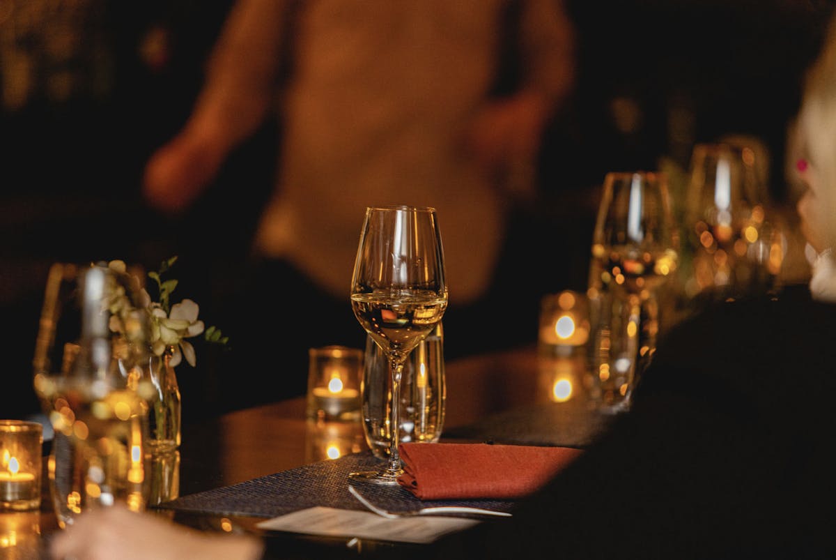 a group of people sitting at a table with wine glasses