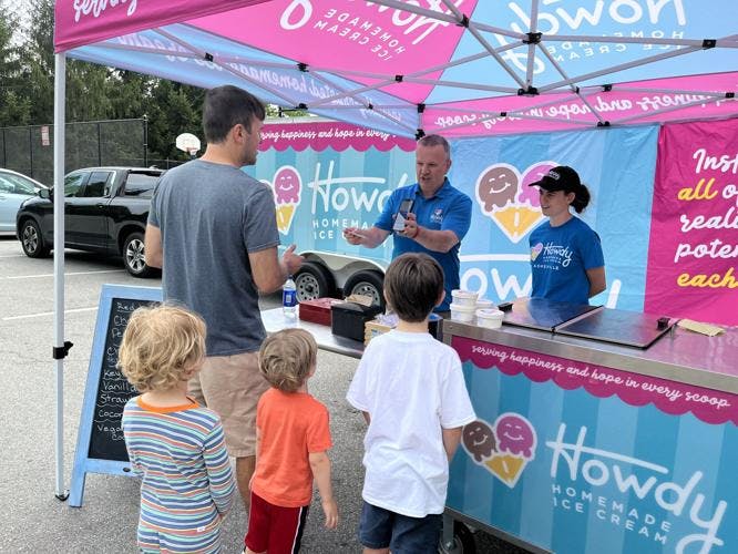 Asheville, NC shop owner Pete Brewer selling ice cream outside at a neighborhood event